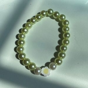 Handmade bracelet with a flower tree in the middle, yellow and white